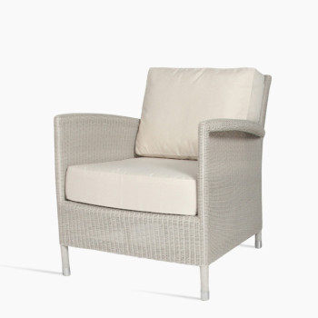 Vincent Sheppard Safi lounge chair in old lace with a woven rattan design, featuring cushioned seat and backrest for added comfort.